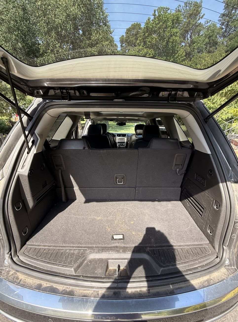GMC Acadia cargo area before detailing, dusty carpet